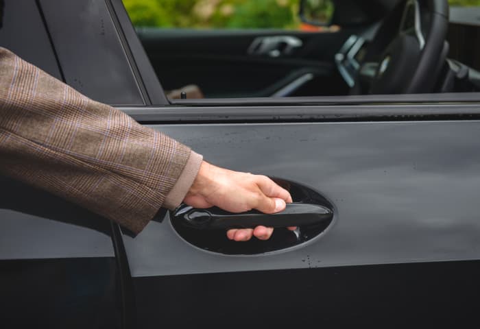 Close up of person openibg car door