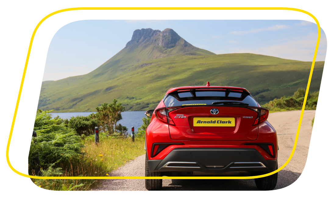 Red car in front of a hill