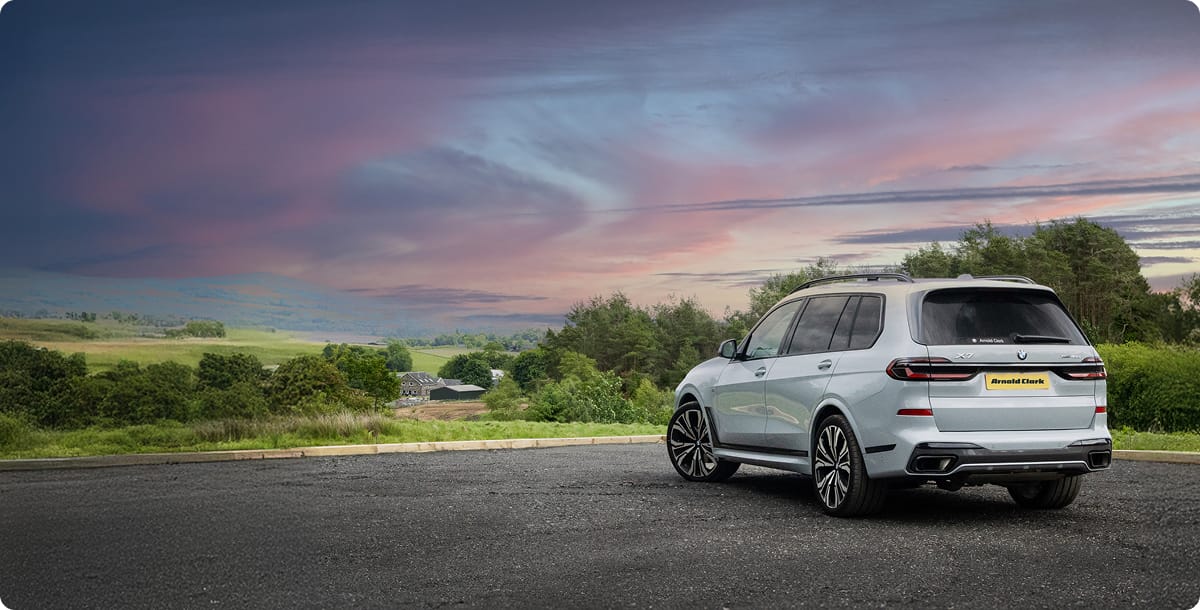 Angled rear view of BMW X7 with sunset background